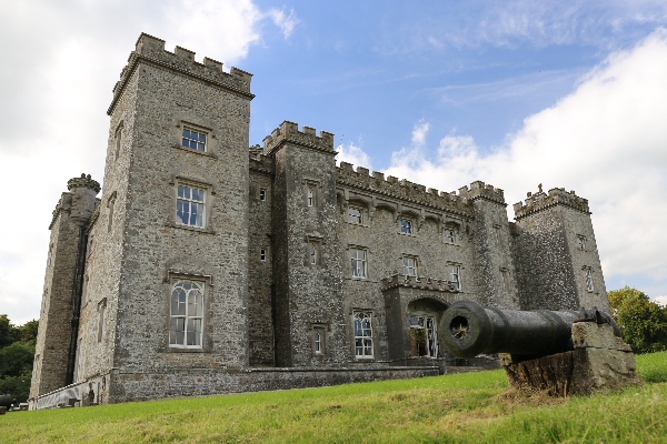 The exterior of Slane Castle in Ireland with a cannon on the lawn